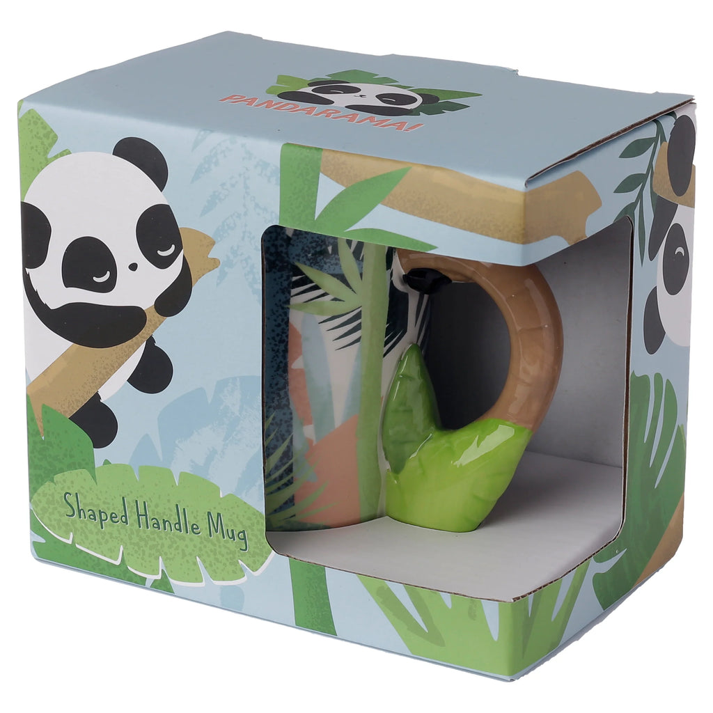 Angled view of a Pandarama Panda ceramic mug, prominently displayed within its light blue illustrative packaging box. The mug's unique green and brown bamboo-shaped handle is clearly visible through the box's front window, alongside glimpses of the mug's jungle-themed design. The packaging features cartoon pandas and bamboo foliage.