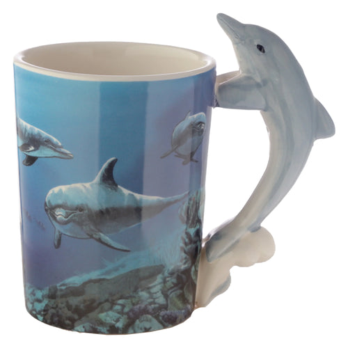 Angled view of a ceramic mug with a shaped dolphin handle. Its blue body is decorated with a vibrant underwater scene featuring swimming dolphins.