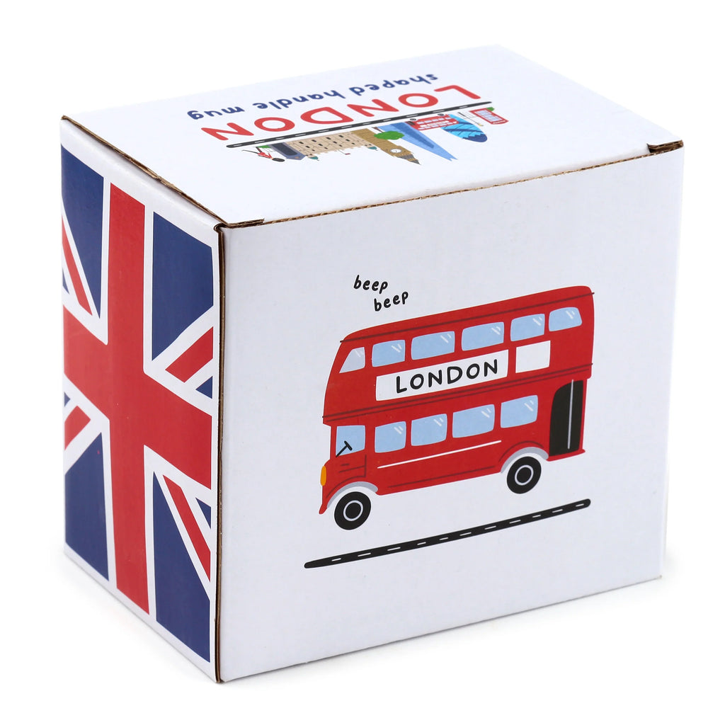 Angled view of a white cardboard mug packaging box, featuring a red London double-decker bus illustration on one side, a Union Jack flag design on another, and 'LONDON shaped handle mug' text with a London cityscape on the top.