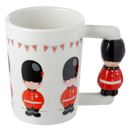 Angled view of a white ceramic mug, featuring cartoon Guardsmen illustrations and Union Jack bunting, with a shaped Guardsman figure handle.