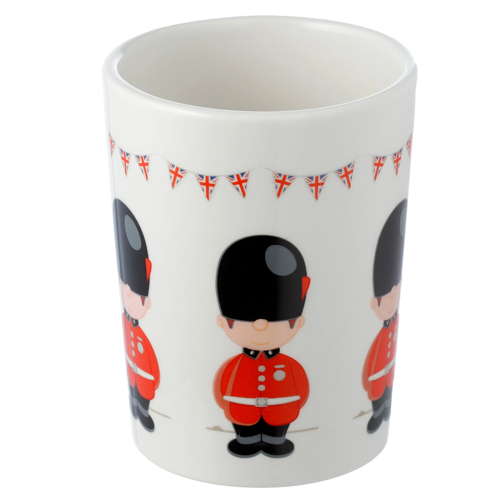 White ceramic mug displaying cartoon Guardsman figures and Union Jack bunting.