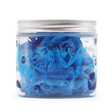 Front view of a clear jar filled with blue swirled blueberry whipped soap, topped with a silver lid and featuring blueberry illustrations on the jar.