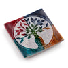 Angled view from above of a multi-coloured soapstone incense burner dish featuring a white carved Tree of Life design with a central incense stick hole.