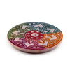 Angled top view of a vibrant multi-coloured soapstone incense burner dish, featuring an intricate carved sunburst design with central holes for incense sticks.
