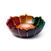 Angled view of a carved soapstone chakra lotus incense burner dish, with multi-coloured petals featuring white detailing and a natural-coloured central incense stick holder.