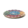 Angled view from above of a circular, carved soapstone incense burner dish, featuring a colourful chakra lotus design with a central hole.
