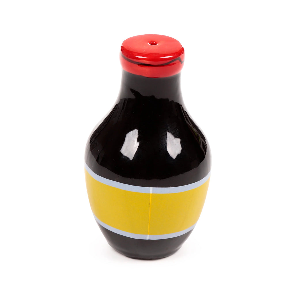 Angled view of a ceramic salt or pepper shaker, featuring a glossy black body, a yellow band with silver stripes, and a red dispensing cap.