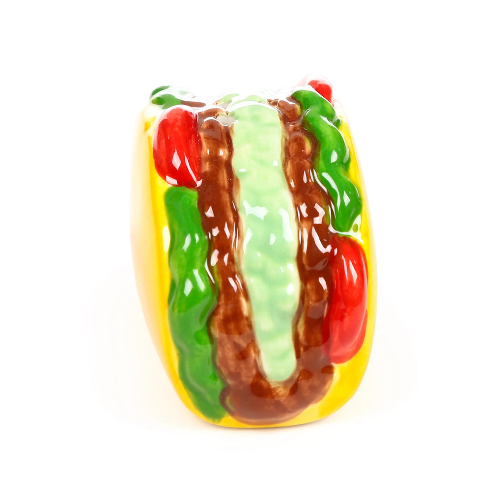 Ceramic taco-shaped salt and pepper shaker, angled view, showing a yellow taco shell filled with brown, green, and red glazed ingredients.
