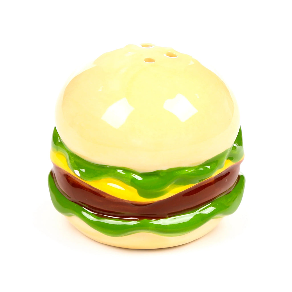 Angled view of a ceramic burger shaker, featuring a glossy yellow bun, green lettuce, yellow cheese, and brown patty details, with three shaker holes on top.