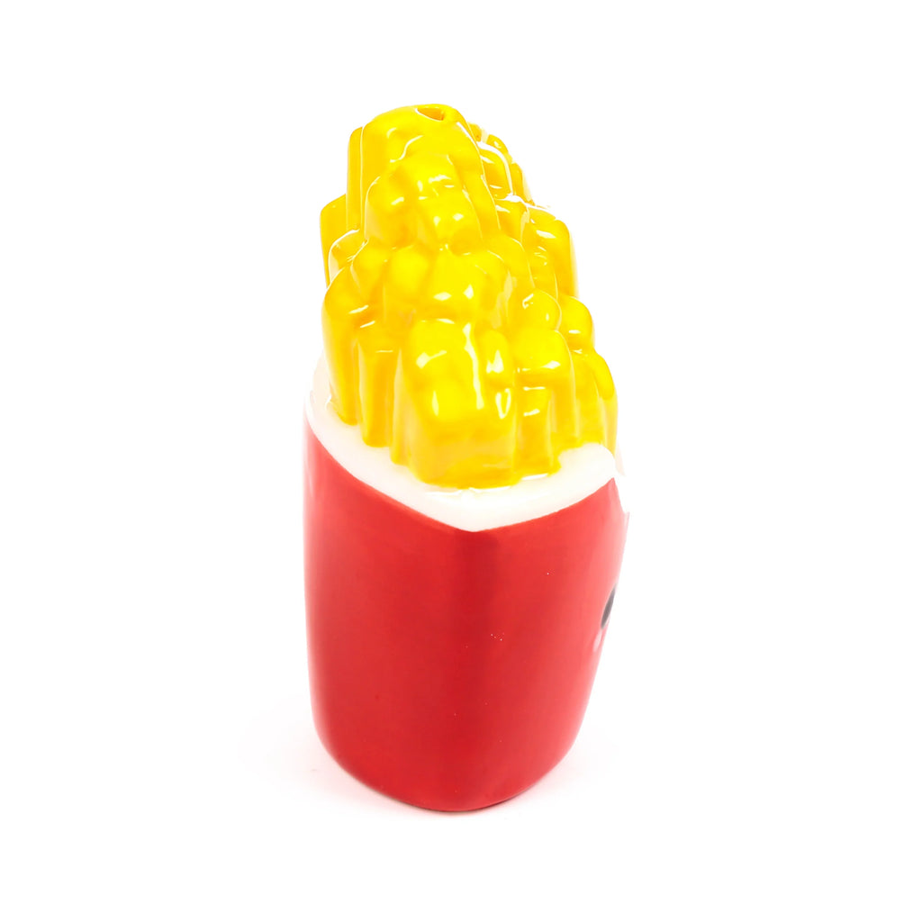 Angled view of a ceramic fries shaker from a salt and pepper set, featuring a red container with yellow chips and a top dispensing hole.
