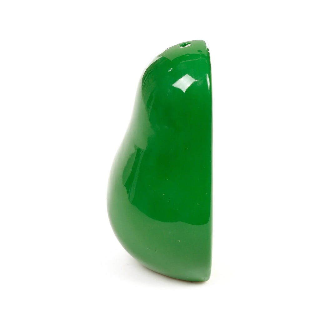 Glossy green ceramic avocado-shaped shaker, shown in profile, with two dispensing holes.