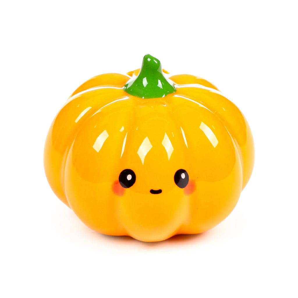 Front view of a bright orange ceramic pumpkin salt or pepper shaker with a green stalk and a cute cartoon face, featuring black eyes, a small mouth, and pink cheeks.