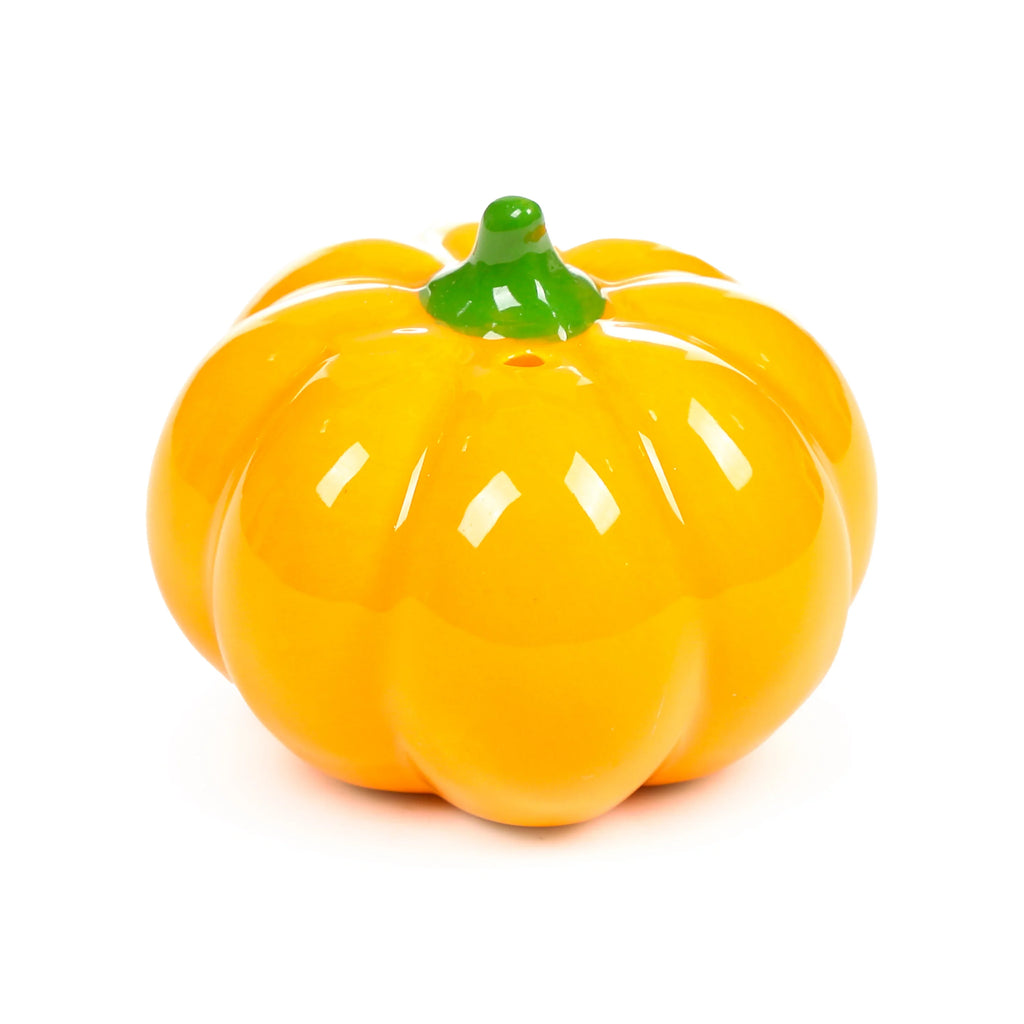 Vibrant orange glossy ceramic pumpkin shaker with a green stem and visible holes for dispensing.