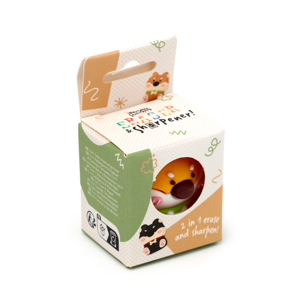 Angled view of a cute Shiba Inu dog 2-in-1 pencil sharpener and eraser set. The brown, black, and white dog's head is visible through a circular window in the cream-coloured, green, and brown patterned packaging box.