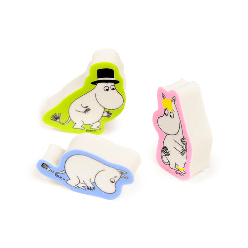 Angled view of a set of three white erasers depicting Moomin characters. One eraser shows Moomintroll in a black top hat with a lime green surround, another a crawling character with a blue surround, and a third a female character with a pink surround.