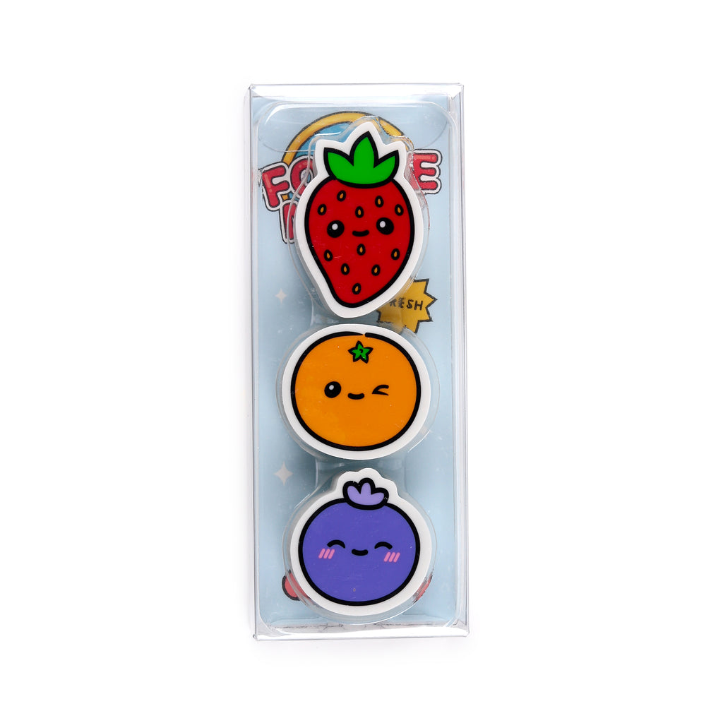 Front view of a three-piece fruit eraser set in clear packaging, featuring a red strawberry, an orange, and a purple blueberry, each with a cute, smiling face, on a white background.