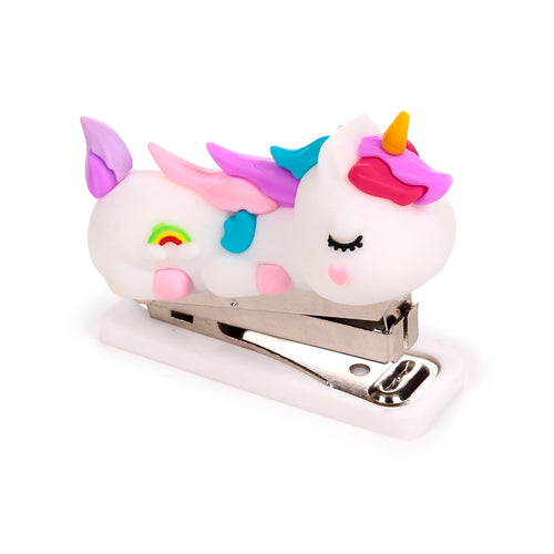 Angled view of a white unicorn mini stapler, featuring a colourful pastel mane, wings, and a rainbow motif on its side, with a metallic stapling mechanism.