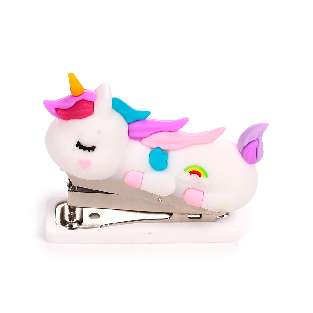 Side view of a white mini unicorn stapler, featuring closed eyes, a yellow horn, pink and fuchsia mane, light blue and pink wings, and a rainbow motif on its side.