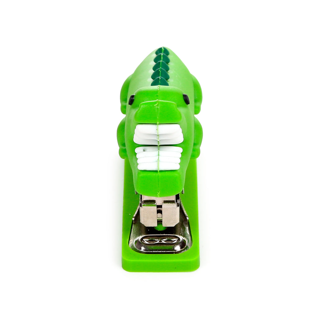 Front view of a green mini shaped crocodile stapler, displaying its white teeth and metallic stapling mechanism.