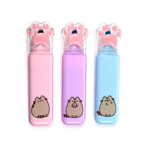 Front view of three Pusheen the Cat highlighters standing upright, featuring distinct pink, purple, and light blue bodies with individual Pusheen illustrations and clear cat paw-shaped caps with pink pads, all on a white background.