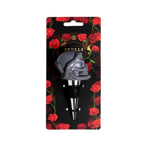 Front view of a novelty bottle stopper featuring a gray skull with a snake wrapped around it, displayed on black retail packaging adorned with red roses.