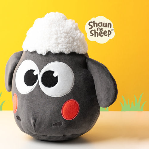 Plush toy of a sheep with a yellow background and 'Shaun the Sheep' logo.