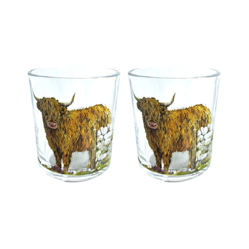 Front view of two clear glass tumblers, each depicting a shaggy brown Highland coo with horns standing by a stone wall amidst green and purple foliage.
