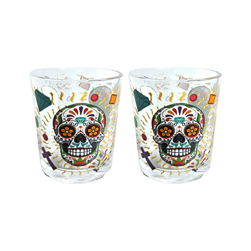Angled view of two clear glass tumblers, each featuring a vibrant Day of the Dead sugar skull and intricate colourful patterns.