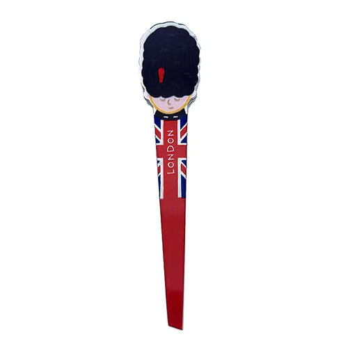 Front view of shaped tweezers, depicting a London Guardsman's head with a bearskin hat. The body of the tweezers features a Union Jack flag design with 'LONDON' written vertically.