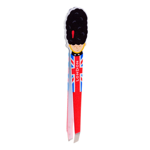 Front view of shaped tweezers, designed as a London Guardsman with a black bearskin hat and a red uniform featuring the Union Jack flag design, with 'LONDON' written vertically.