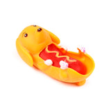 Yellow sausage dog fidget toy lying on its back, showing its red hot dog filling with yellow mustard detail and white paws with pink pads.