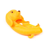 Yellow sausage dog fidget toy lying on its back, with a brown nose and small ears, against a white background.