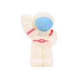 Front view of a white astronaut Space Cadets hatching egg toy, featuring a blue visor, red suit details, and its right arm raised.