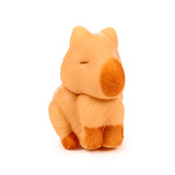 Light brown capybara hatching egg toy with darker nose and closed eyes, pictured from the front.