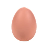 Upright view of a light brown hatching egg toy, showing two small holes at the top.