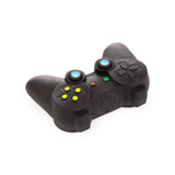 Angled view of a black game controller-shaped stretchy stress fidget toy, featuring blue analogue sticks, a directional pad, four yellow circular buttons, and coloured face buttons (red, green, yellow, blue).