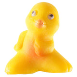 Front view of a bright yellow novelty hatching chicken toy with black eyes and an orange beak.