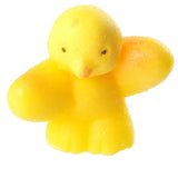 Close-up angled view of a yellow textured novelty hatching chicken toy, showing its small eyes and pointed beak.
