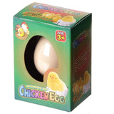 Angled view of a Fun Kids Novelty Hatching Chicken egg toy in its green retail packaging, showcasing the white egg through an oval cutout and featuring colourful chick illustrations.