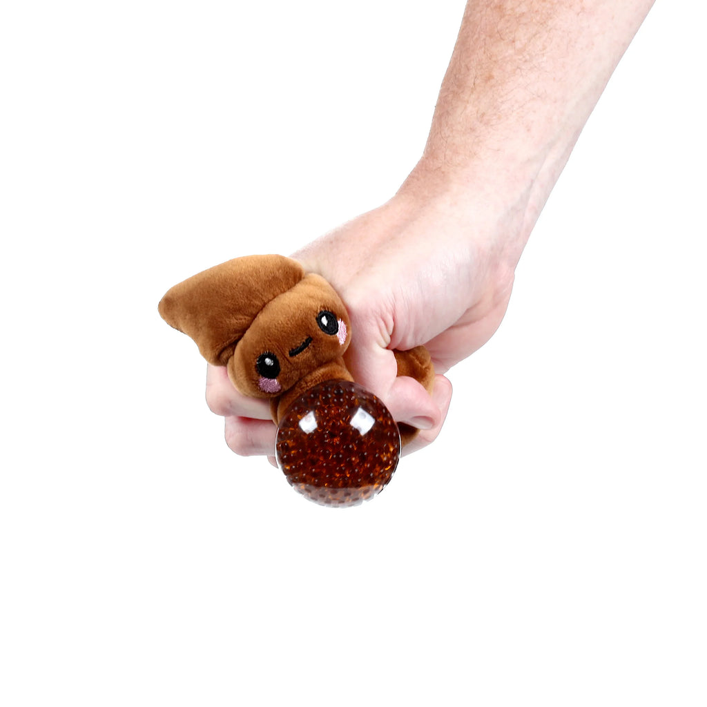 Close-up of a hand squeezing a brown poop fidget toy with a cartoon face, embroidered eyes, pink cheeks, and a clear, bead-filled squishy ball.
