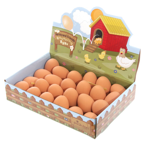 Elevated view of a retail display box filled with Fun Novelty Bouncing Rubber Eggs. The box features farmyard illustrations, including a chicken coop and various cartoon animals.