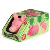 Angled view of a pink Fun Kids Stretchy Squeezy Pig toy, visible through a cut-out in its light green, polka-dotted retail box. The pig's head is prominent, and the packaging displays illustrations of a pig and 'Squeeze me!!' text.