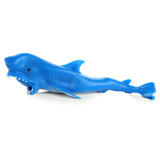 Side view of a blue stretchy squeezy shark toy with an open mouth and visible white teeth.