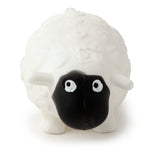 Front view of a white squeezy sheep toy, featuring a textured wool effect body, black face with white eyes and black pupils, one with a distinctive tear-like drip, and short white legs, presented on a white background.