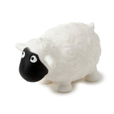 Angled view of a white squeezable sheep toy with a textured fleece body, black face, and white eyes.