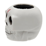 Side profile of a white skull pop out toy with a red forehead mark and hollow black interior.