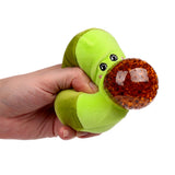 Hand squeezing a light green avocado fidget toy, showcasing its black embroidered eyes, subtle pink cheek details, and a bulging brown bead-filled pit, on a white background.