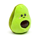 Front view of a plush lime green Queasy Squeezies avocado fidget toy, featuring an embroidered smiley face with pink cheeks and a dark brown squishy pit filled with small orbs.