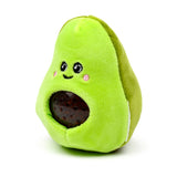 Bright green plush avocado fidget toy, displaying its embroidered smiling face with pink cheeks and a dark, visible squishy pit filled with beads.
