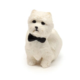 Front view of a white West Highland Terrier stretchy fidget toy with a black bowtie.